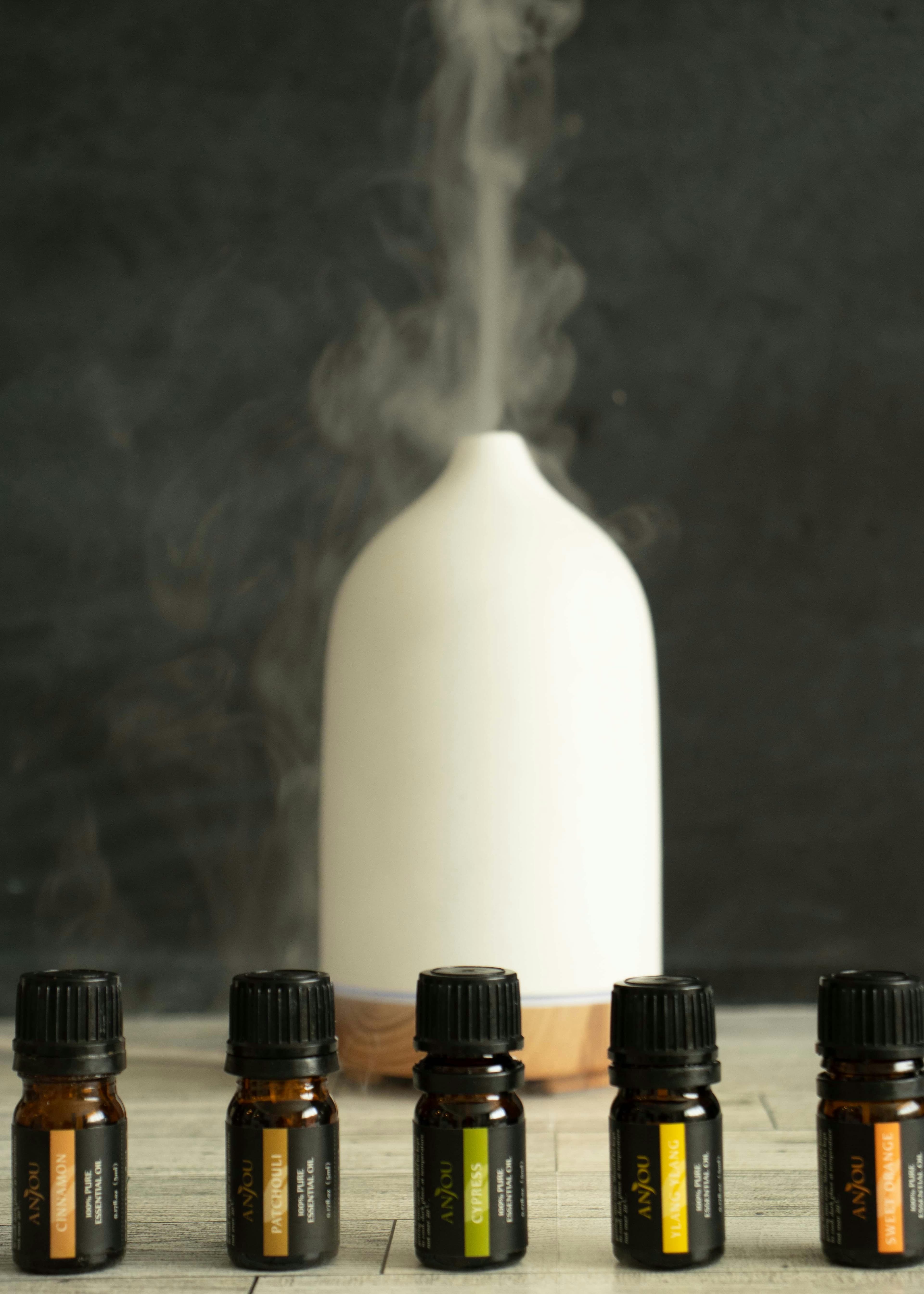 Stylish aromatherapy diffuser with essential oils emitting soothing mist indoors.