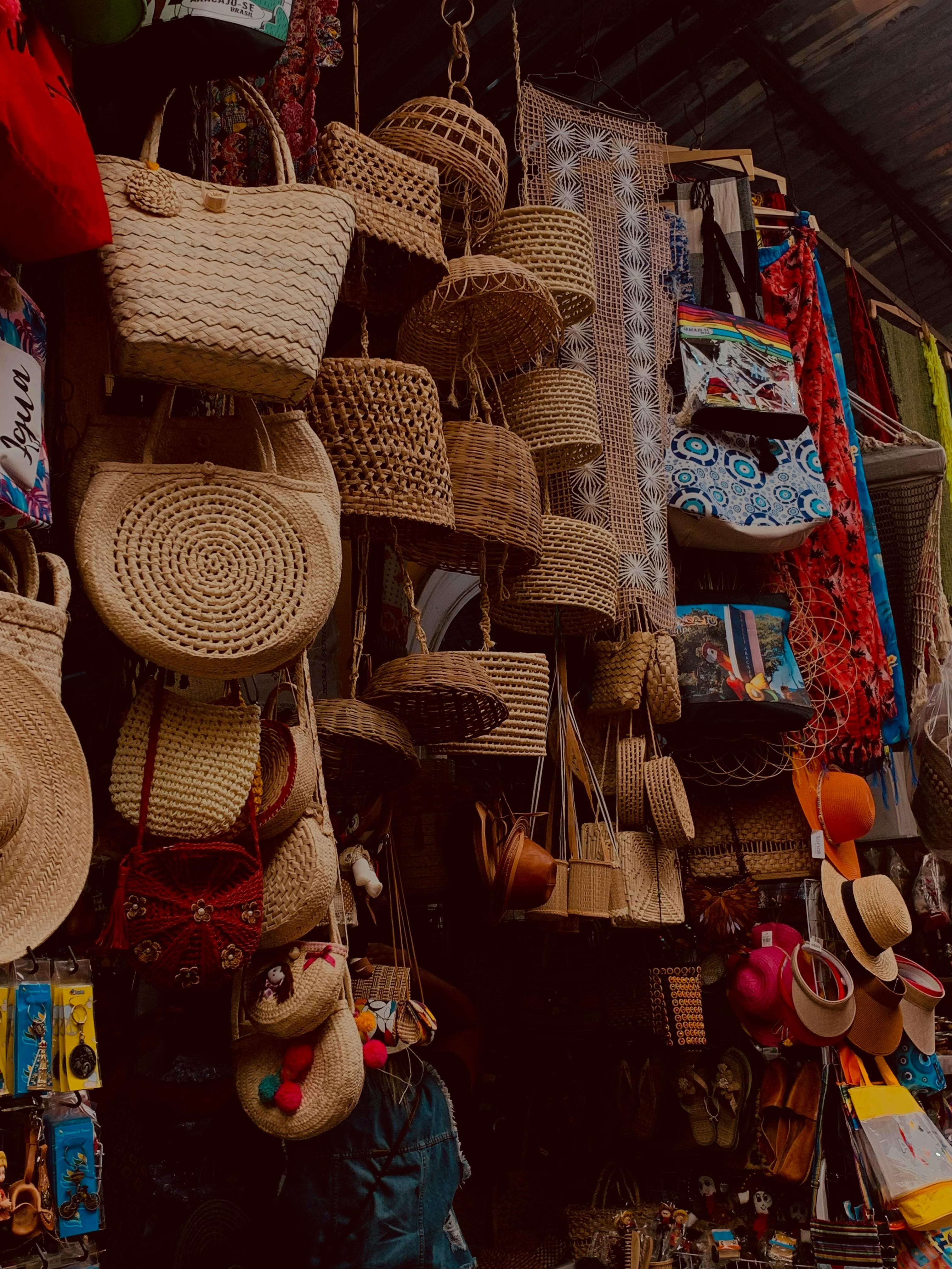 Artistic display of handmade wicker baskets at an outdoor market, showcasing traditional craftsmanship.